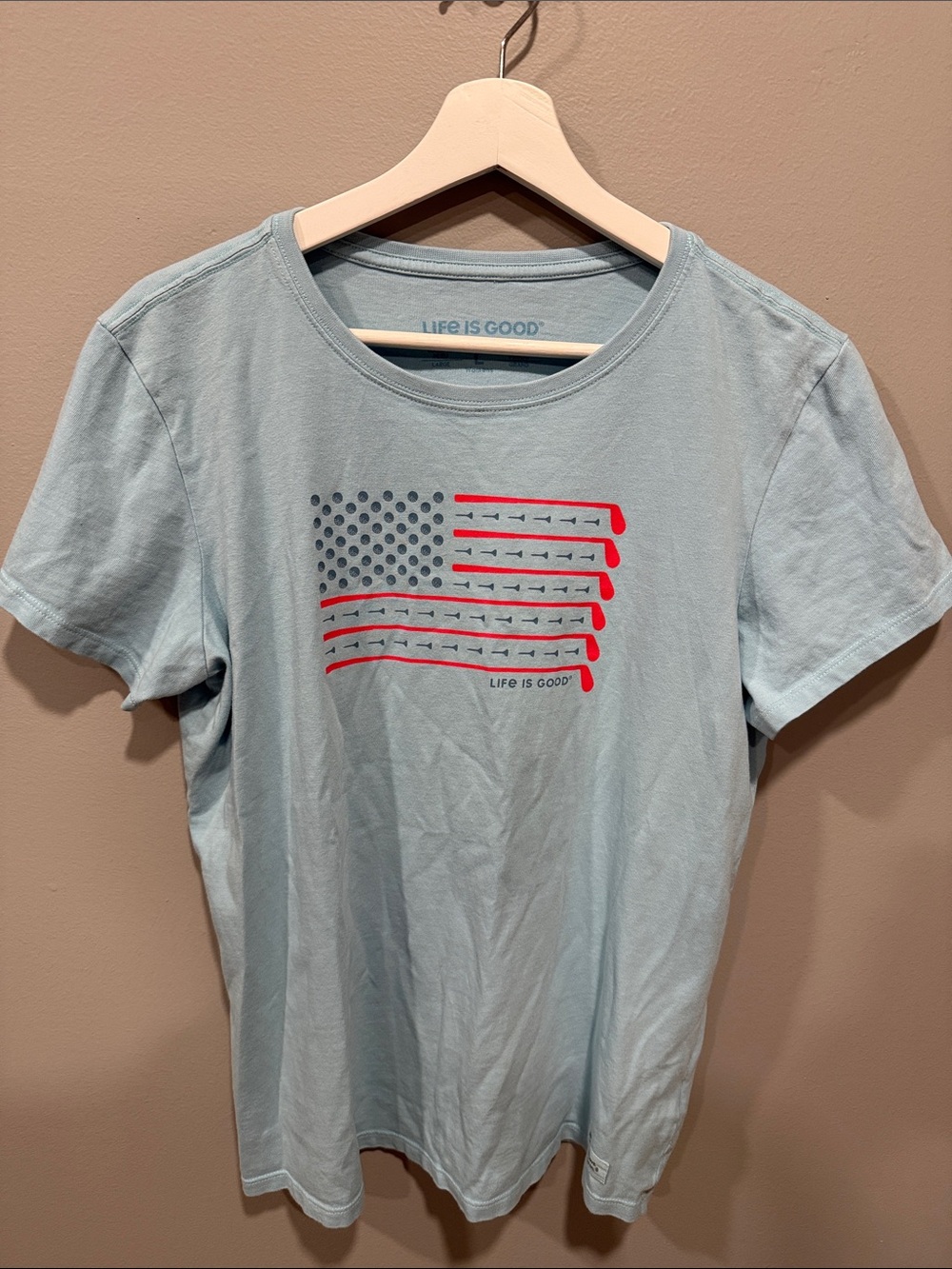 Life Is Good Women’s Light Blue Tee with Red & Navy Flag Graphic